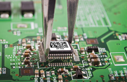 Microchip with durable barcode label being installed on PCB board