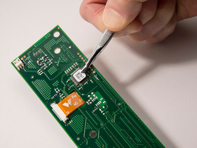 circuit board with barcoded microchip being installed