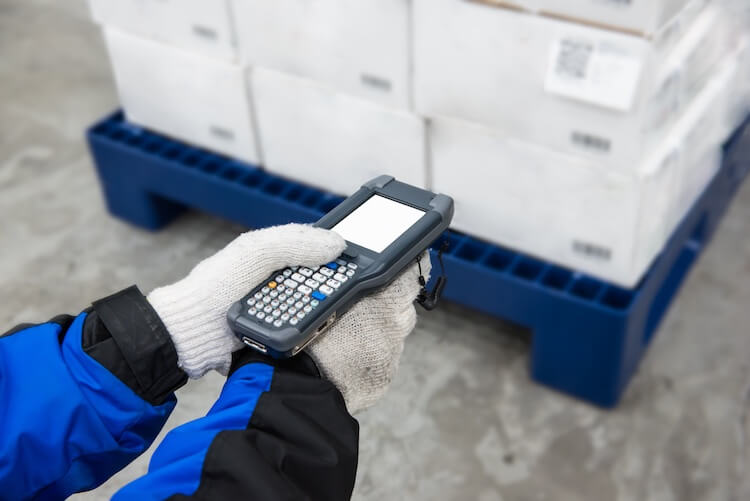 man scanning warehouse freezer label