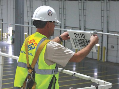 installing overhead warehouse barcode sign