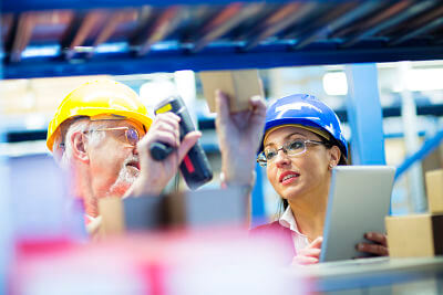 Warehouse workers with barcode scanner checking inventory