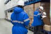 Three cold storage warehouse workers checking inventory