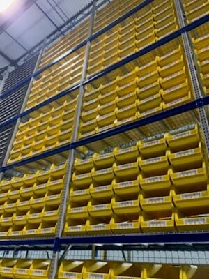 Wide shot of yellow warehouse bins and barcode labels