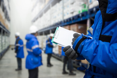 Warehouse workers in cold storage facility
